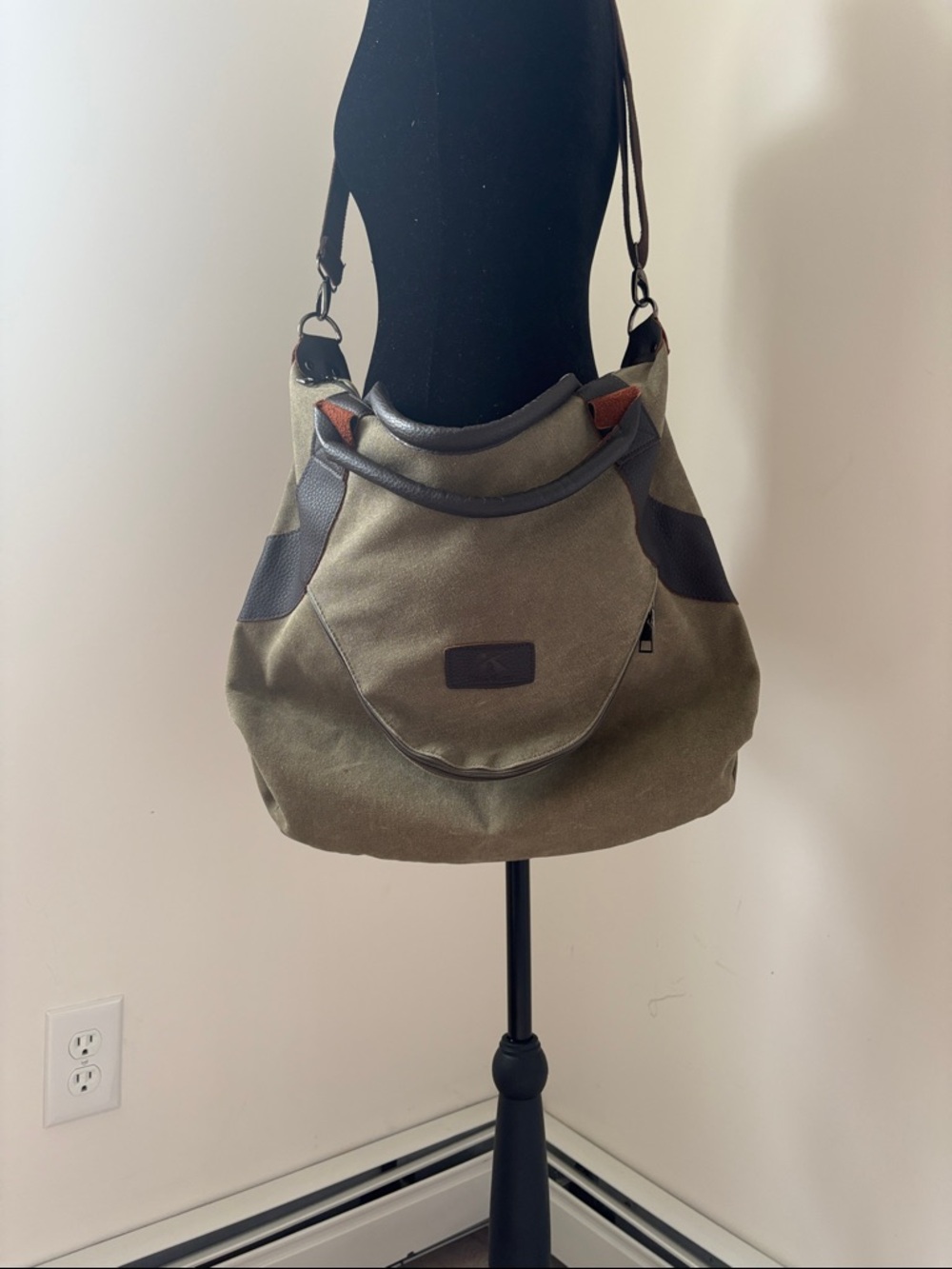 Canvas bag with adjustable shoulder strap and handles.
